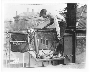 1930s-6 -
An aerial lineman gassing aerial cable.