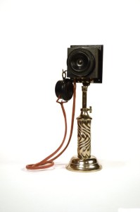 Title: Speaking tube
Description: Speaking tube set mounted on a No. 2 desk stand 1892 — 1900. The telephone of the Gay Ninties was a compact model with a "watch case" receiver and ornate base. This telephone is also known as "speaking tube". Reproduction by John Infurna.
Date: 1892